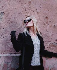 stylish-sunglasses-woman-on-wall